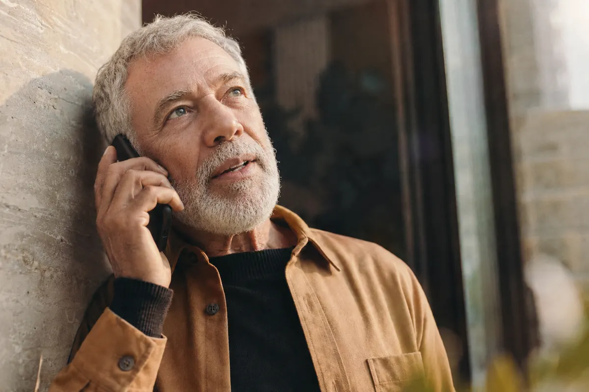 An older patient taking a phone call